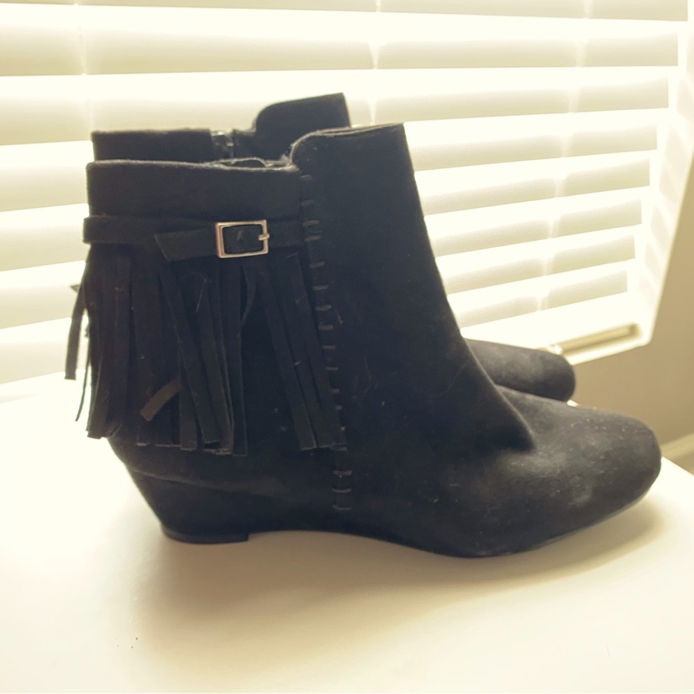 Black ankle boots . Zipper on side and fringe detail . Never worn . Size 10
